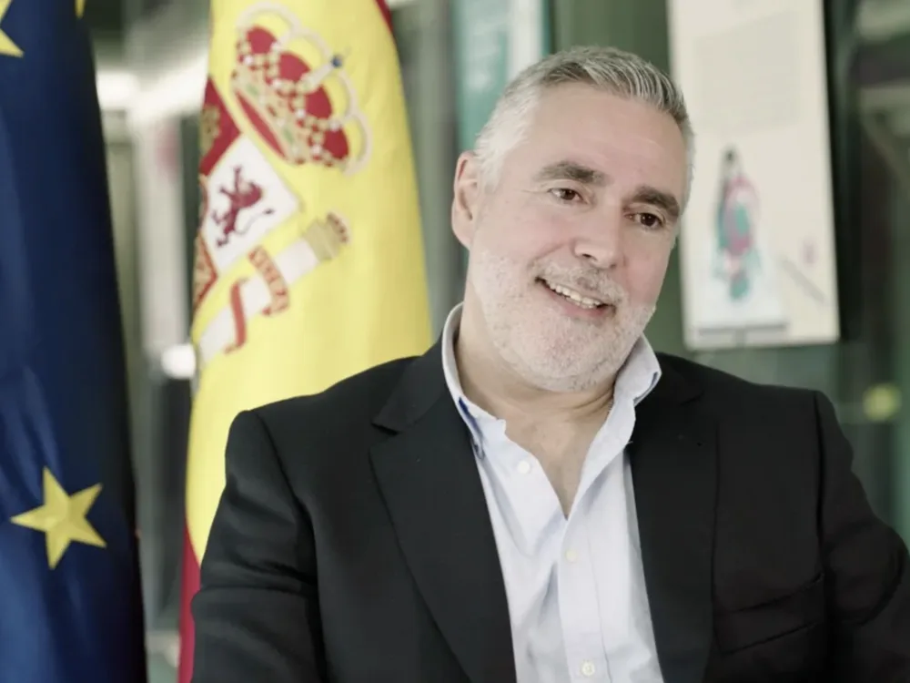 Sebastián J. Brau in an institutional interview with EU and Spain flags